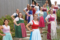 Frauen im Dirndl stehen auf Treppe